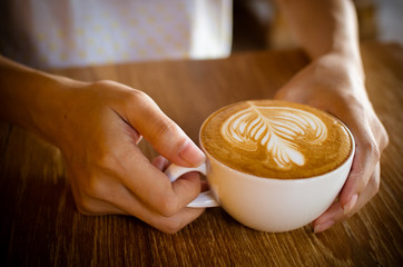 Cup of coffee latte in coffee shop.