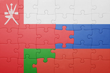 puzzle with the national flag of oman and russia
