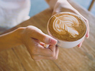 Cup of coffee latte in coffee shop.