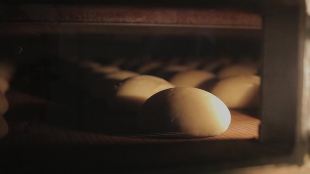 The bread on the conveyor oven. Bread bakery food factory 