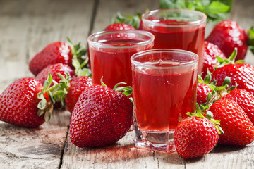Red strawberry drink and fresh berries, selective focus