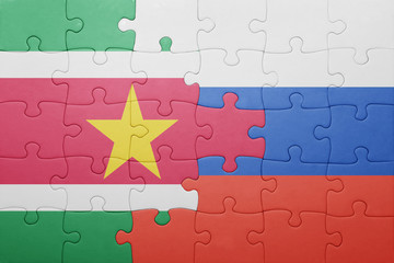 puzzle with the national flag of suriname and russia