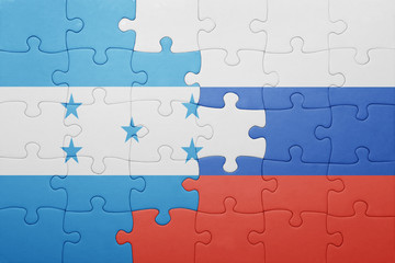 puzzle with the national flag of honduras and russia