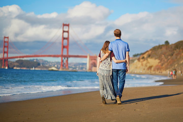 Romantic loving couple having a date on Baker beach in San Francisco