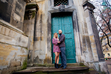 Fototapeta na wymiar beautiful young couple in love standing near historic building.