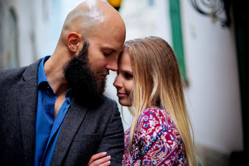 Young funny pretty fashion vintage hipster couple having fun outdoor on the street in summer.