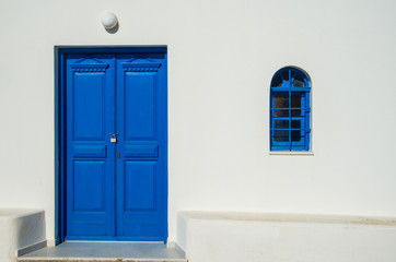 A door and window in the classic Cyclades style on the Greek island of Santorini in Fira town