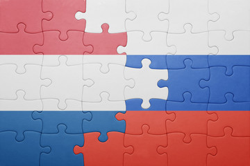 Fototapeta premium puzzle with the national flag of netherlands and russia