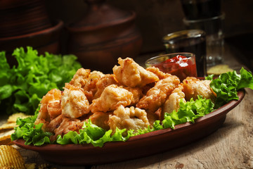 Fototapeta premium Nuggets, chicken tempura with green salad and tomato sauce on a