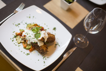 Grilled meat with sauce and herbs served at restaurant