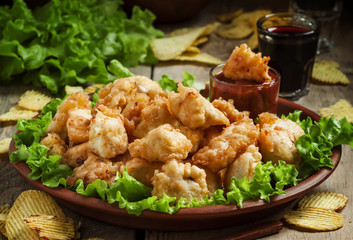 Fototapeta premium Nuggets, chicken tempura with green salad and tomato sauce on a