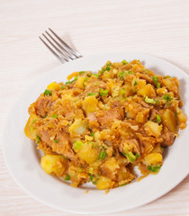 stewed meat with potatoes, onion on plate