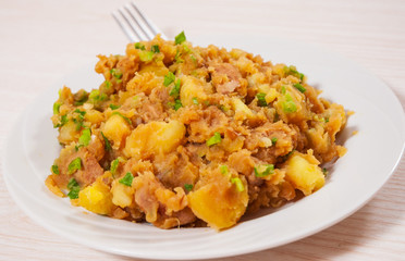stewed meat with potatoes, onion on plate