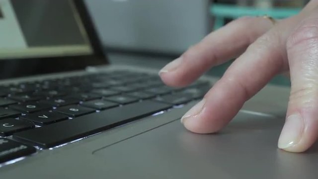 Hands of a woman using a laptop