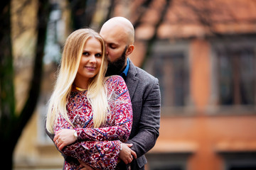 Young couple in love, hugging on the street. Selective focus. ba