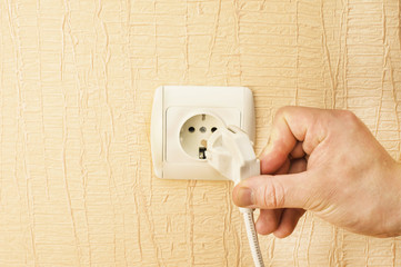 The process of connecting the white plug into the socket