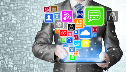 Business man using tablet PC with social media icon set
