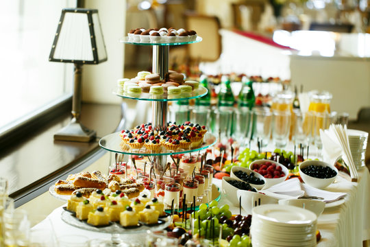 Delicious and tasty dessert table at wedding reception macaroons