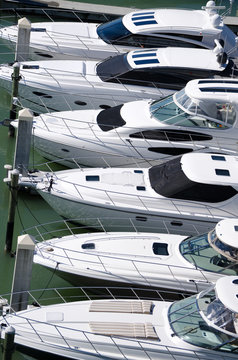 Fototapeta Rows of luxury yachts lined up at a marina dock