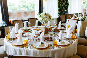 Elegant stylish decorated wedding reception tables with glasses