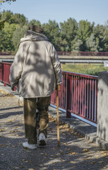 senior man walking with cane at park