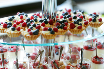 Delicious sweet cupcakes and pastry at wedding  dessert table re
