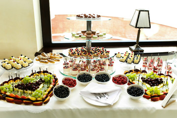 Delicious and tasty dessert table at wedding reception macaroons