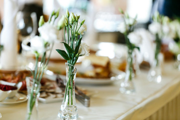 Elegant stylish decorated wedding reception tables with glasses