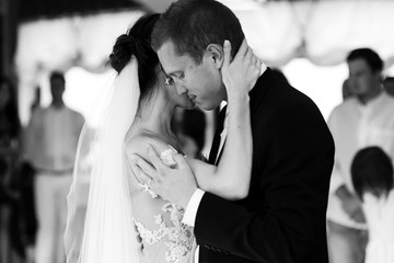 Happy newlywed bride and groom dancing at wedding reception clos