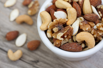 Bowl of Mixed Nuts on Rustic Wooden Table