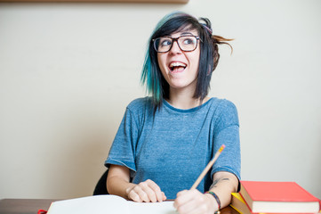 Young happy female teen student with book