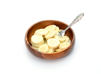 Bananas topped with milk on white background