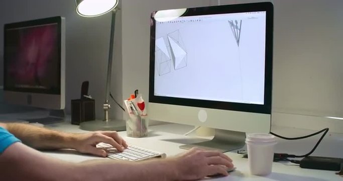 Engineer using computer software to create three dimensional models