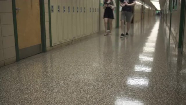 Students walking down hall by lockers