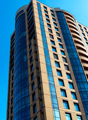 Fototapeta premium Modern building mirror facade in blue tone