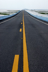 Empty road and the yellow traffic lines.