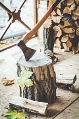 Axe in stump sticking out on veranda