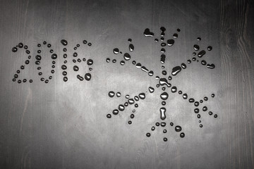 Sign of snowflakes built of water droplets, a number 2016 writte