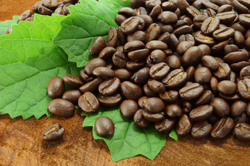 Coffee beans on the wooden background.