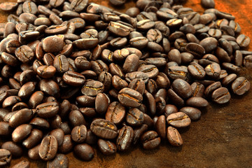 Coffee beans on the wooden background.