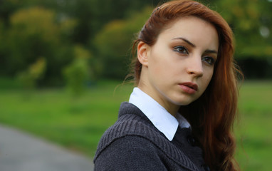 Fototapeta premium red-haired girl in autumn jacket