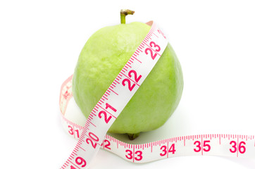 Measuring tape wrapped around a Guava