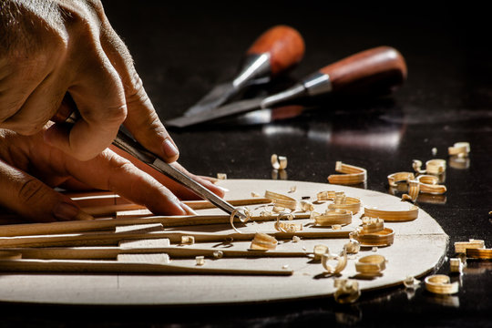 Luthier making top of guitar