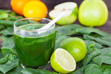 Fruit and vegetable smoothie with spoon in the glass