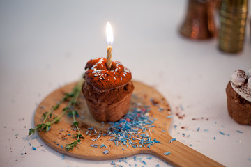 tasty birthday cupcake with candle on the table, blurred background