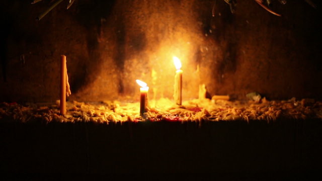 Beautiful dramatic burning candles and melting wax on altar