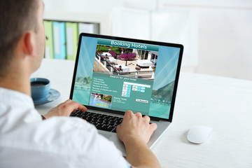 Man using laptop to book hotel online