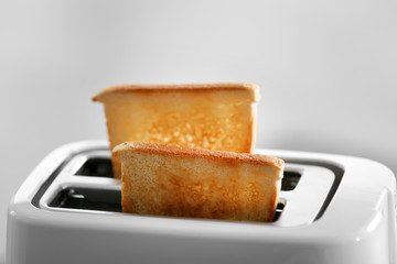 A couple of crusty toasts in the toaster, close-up