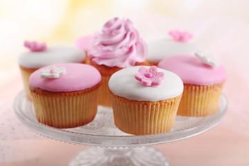 Tasty cupcake on stand, close-up