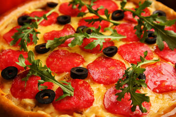 Tasty pizza with salami background, close up